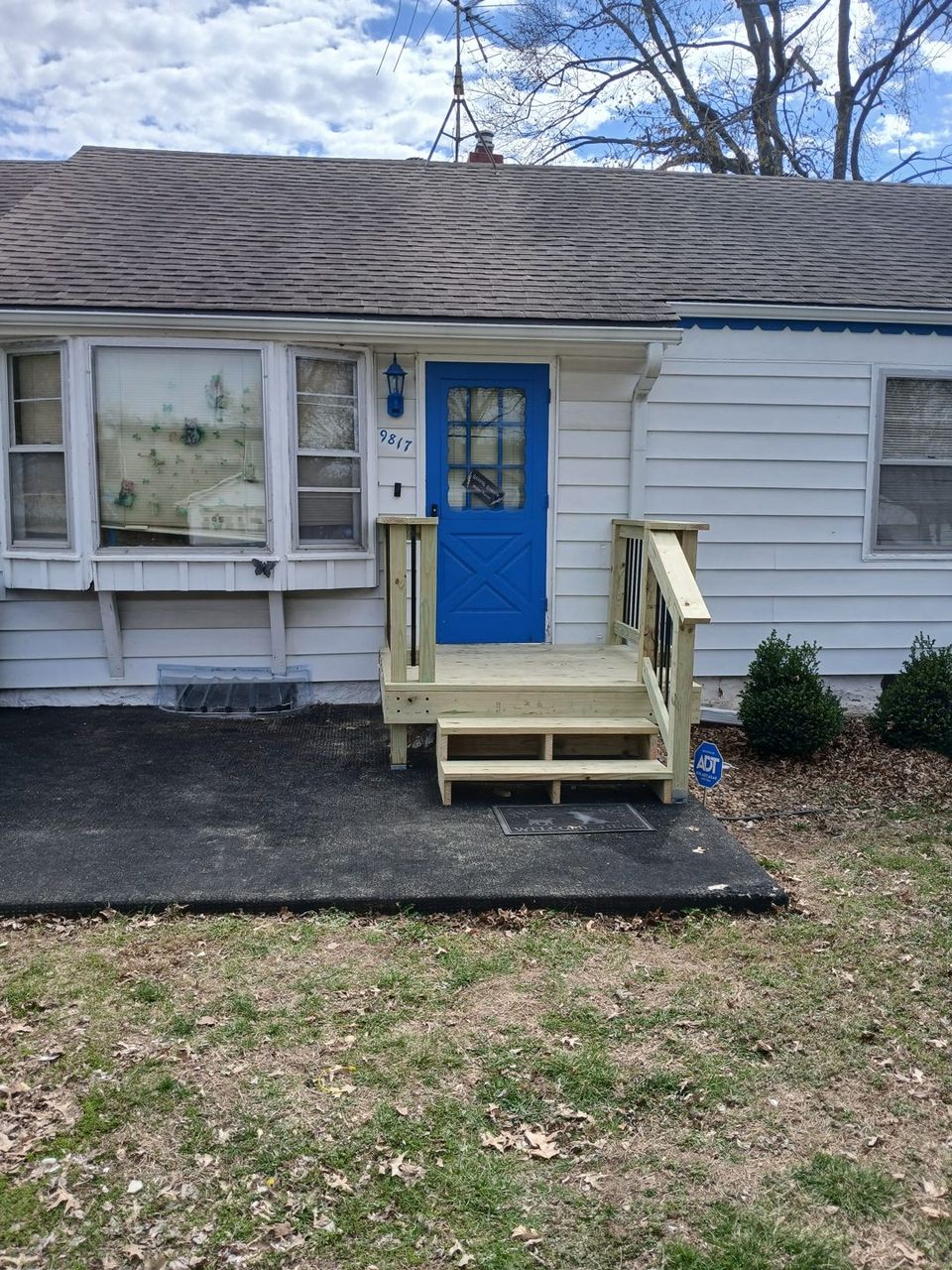 Wood stairs and landing connecting a home to the yard